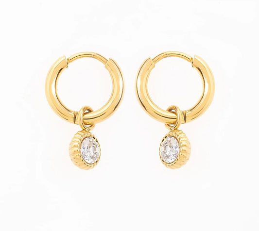 Craque pour ces élégantes boucles d'oreilles créoles, en acier inoxydable et plaqué or, qui sublimeront ton look en un clin d'œil. Chaque anneau arbore un pendentif délicatement serti d'une pierre de zirconium. Adopte-les pour briller en toutes circonstances, et laisse ces créoles rehausser ton style avec une pointe d’élégance.