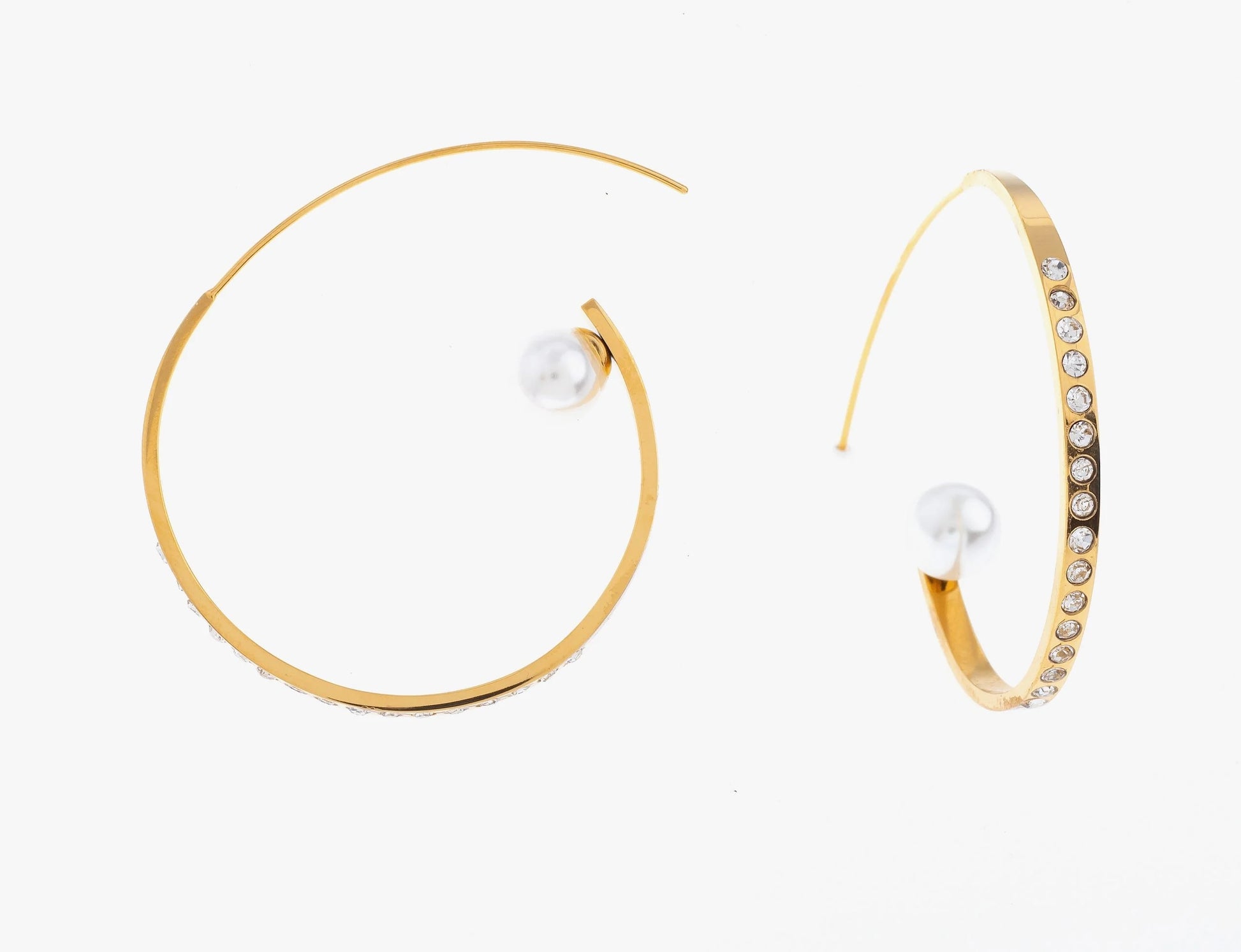 Craque pour ces boucles d'oreilles créoles revisitées, en acier inoxydable et plaqué or. Ces anneaux ouverts en métal sont ornés de strass de plusieurs couleurs sur l’une de leurs faces. À l'extrémité, une perle blanche semble flotter. Légères et faciles à porter, ces boucles sont idéales pour rehausser un look de jour comme de nuit.

