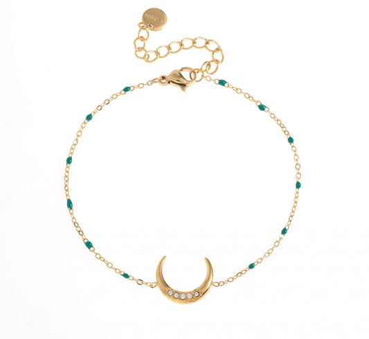 Bracelet Luna maille fine, en acier inoxydable et plaqué or, avec des petites boules bleues délicatement intégrées dans la maille, il a un look à la fois subtil et unique. Le centre de ce bijou est orné d'une lune élégante, toute parée de zircons. Ce bracelet est parfait pour ajouter une touche de magie et de mystère à ton style.