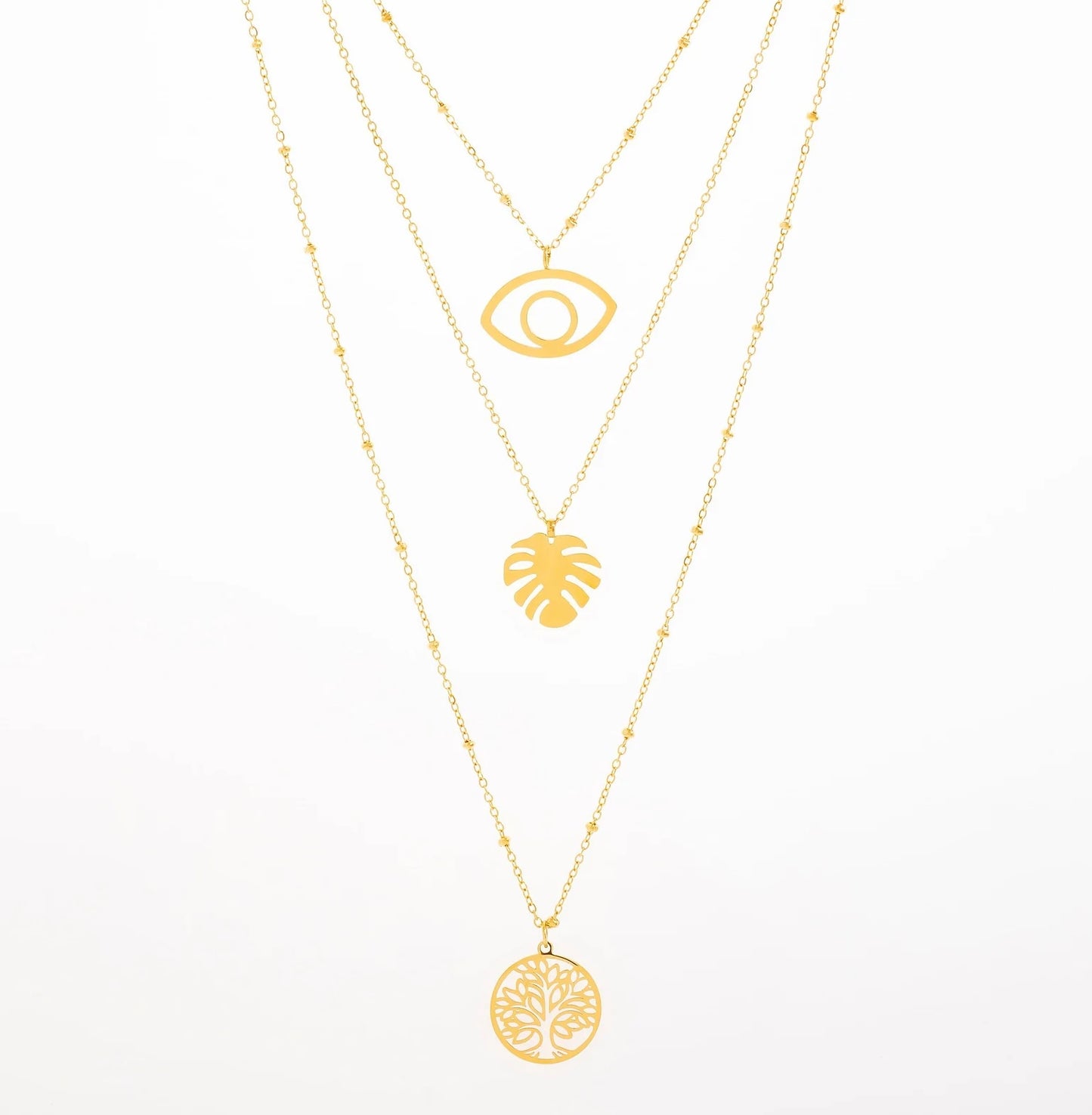 Opte pour notre collier Olga, en acier inoxydable et plaqué or, un bijou qui respire l'été et la bonne humeur. Ce modèle à trois chaînes fines combine des pendentifs ultra tendance. La première chaîne présente un œil, pour une touche protectrice. La deuxième chaîne affiche une feuille de monstera, symbole d'aventure. Enfin, la troisième chaîne se termine par un médaillon Arbre de Vie, parfait pour insuffler une vibe de positivité à ton look. Ajoute ce collier à ta collection pour un effet «wow» garanti !