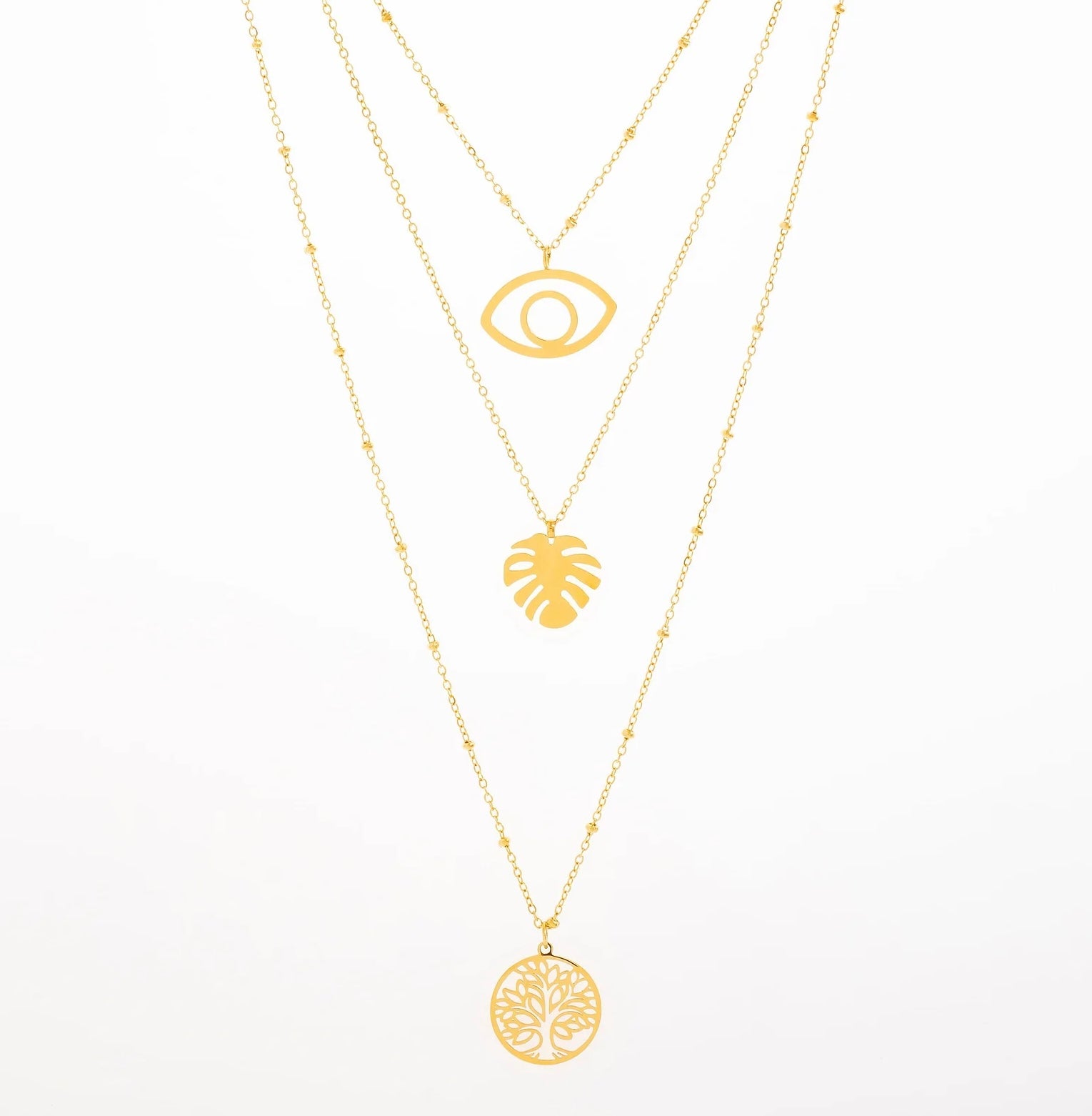 Opte pour notre collier Olga, en acier inoxydable et plaqué or, un bijou qui respire l'été et la bonne humeur. Ce modèle à trois chaînes fines combine des pendentifs ultra tendance. La première chaîne présente un œil, pour une touche protectrice. La deuxième chaîne affiche une feuille de monstera, symbole d'aventure. Enfin, la troisième chaîne se termine par un médaillon Arbre de Vie, parfait pour insuffler une vibe de positivité à ton look. Ajoute ce collier à ta collection pour un effet «wow» garanti !